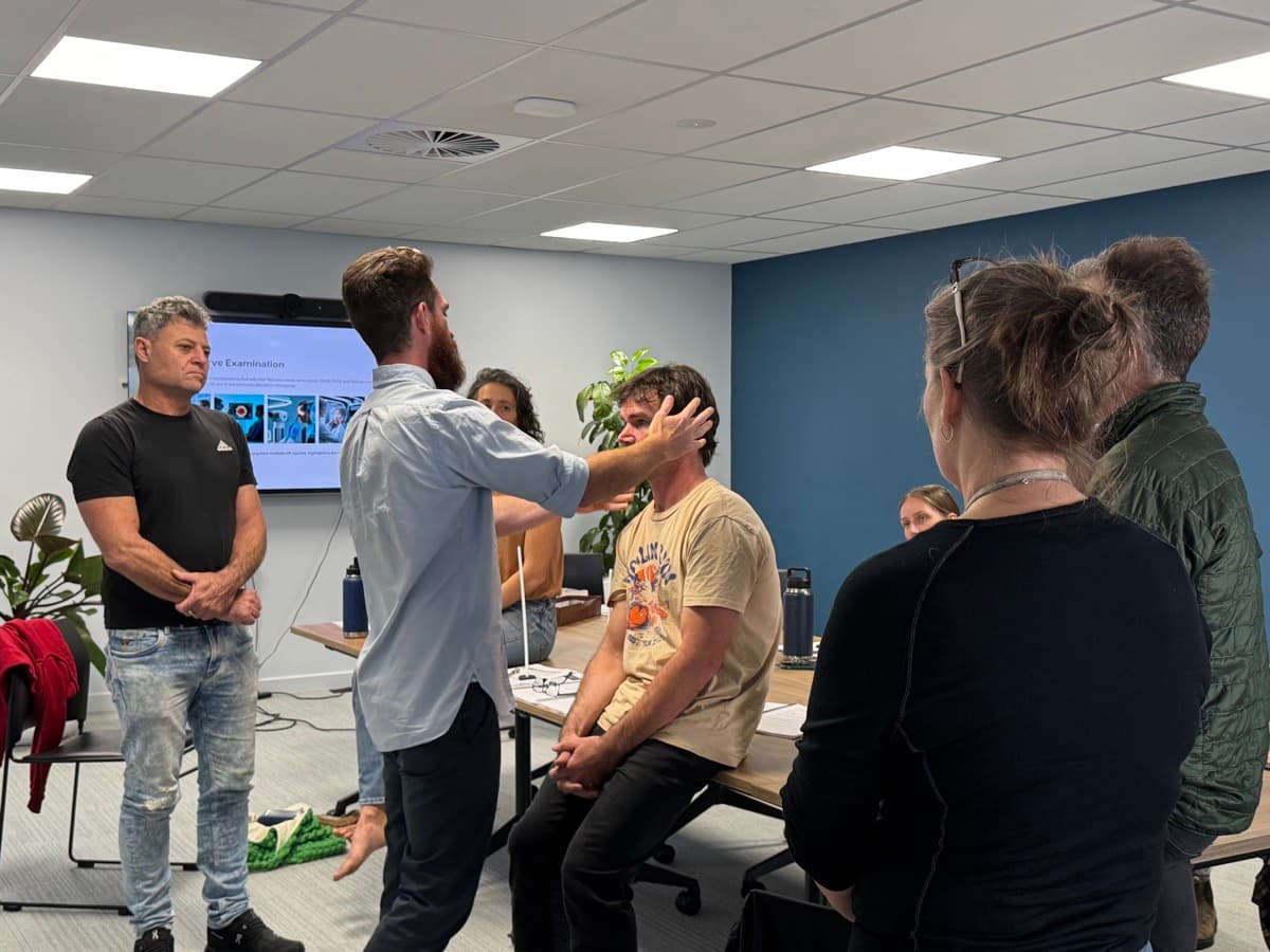 Zac Lewis training a team of clinicians — hands-on concussion examination practice